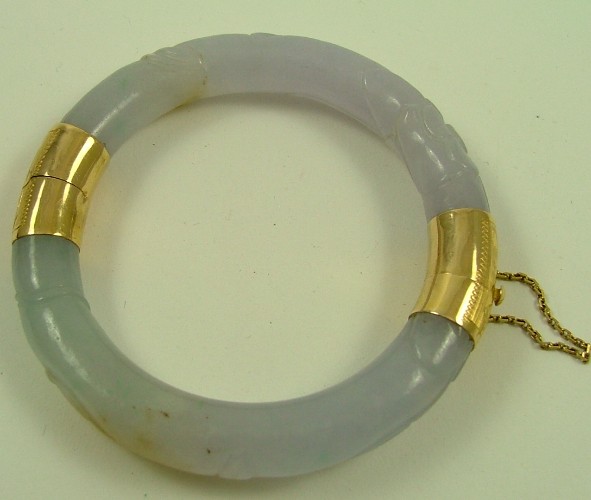 Appraisal: CARVED LAVENDER JADE BANGLE K yellow gold hinge and clasp