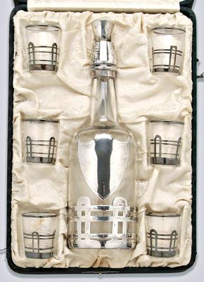 Appraisal: Sterling overlaid decanter set bottle form decanter shield above a