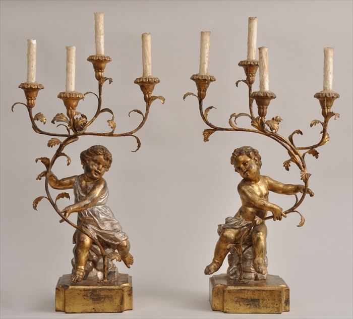 Appraisal: PAIR OF ROCOCO-STYLE CARVED SILVERED AND GILTWOOD FIGURAL CANDELABRA Each