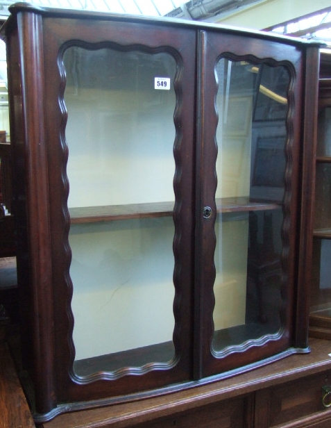 Appraisal: A mahogany small display cabinet with bowfront top and glazed