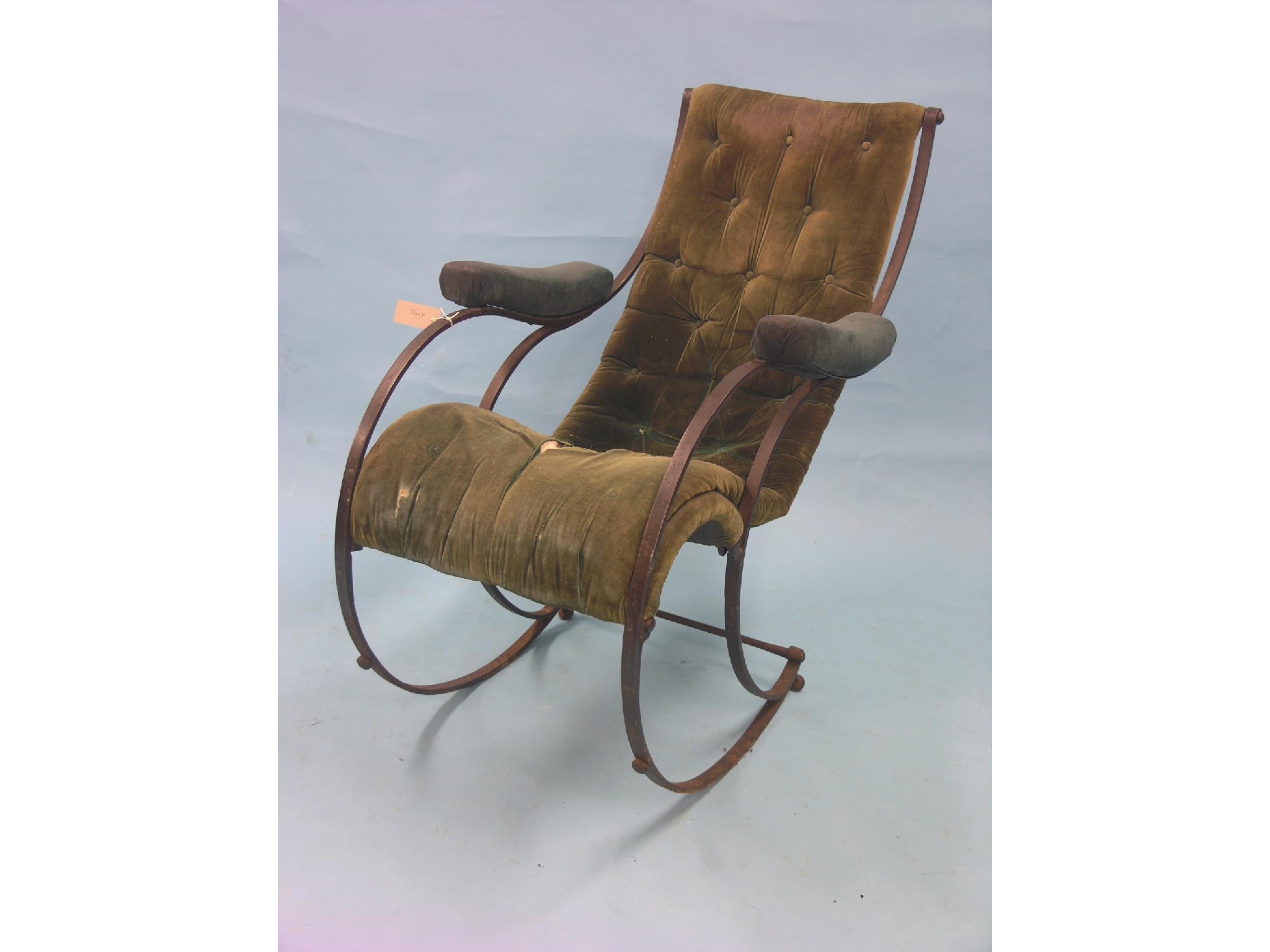 Appraisal: An unusual Victorian iron-framed rocking armchair upholstery as viewed