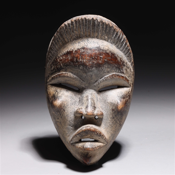 Appraisal: Carved wooden mask in the style of the Dan people