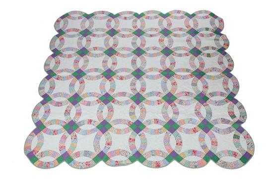 Appraisal: DOUBLE WEDDING RING QUILT Printed fabrics on a white ground