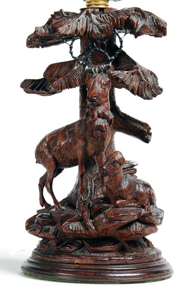 Appraisal: A BLACK FOREST TABLE LAMP early th century modelled as