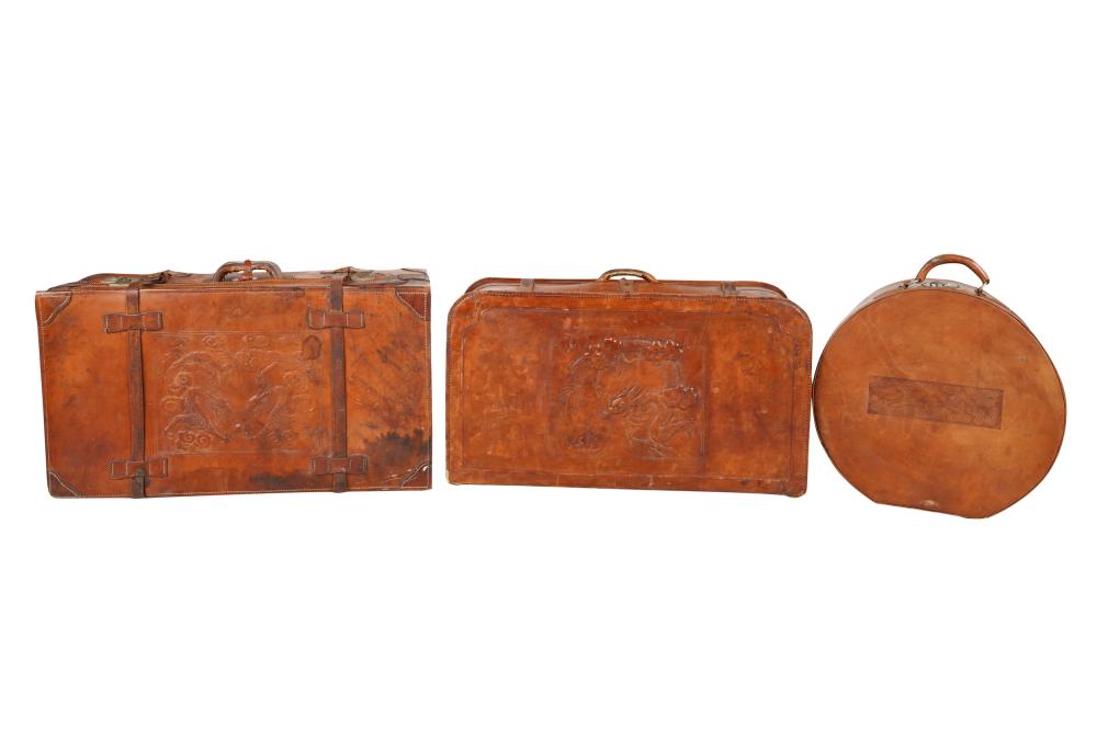 Appraisal: THREE LEATHER EMBOSSED SUITCASEScomprising a hatbox and two leather suitcases