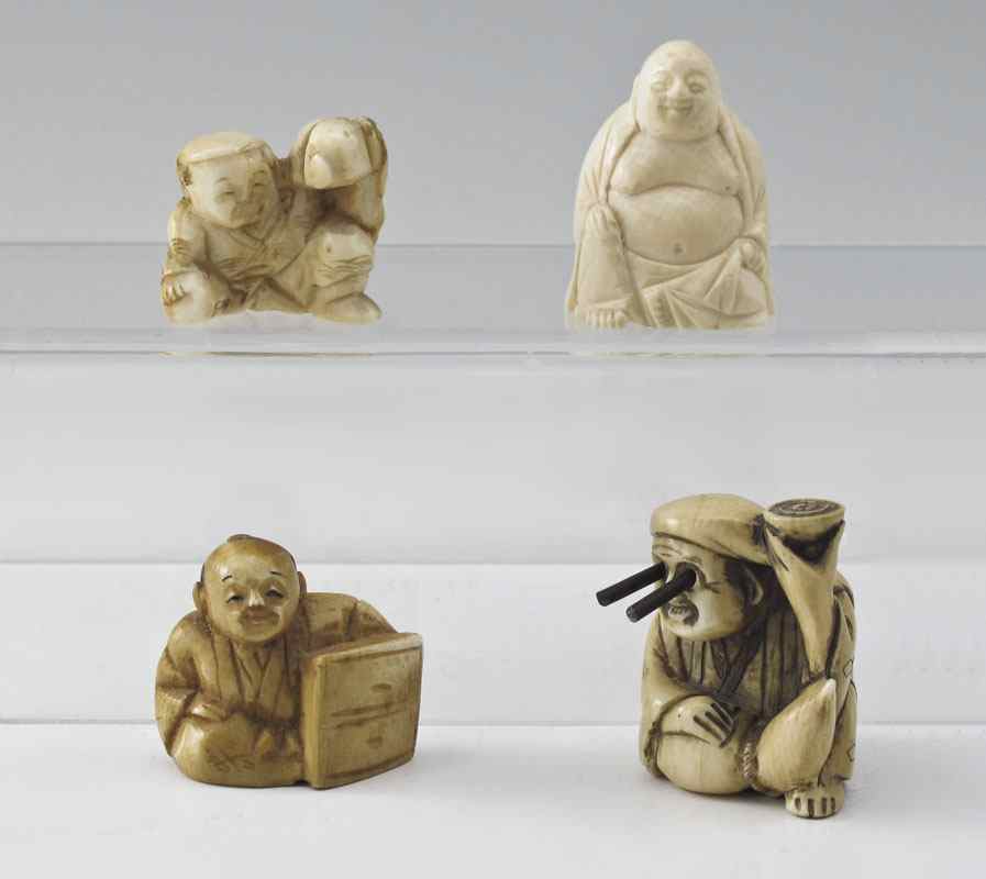 Appraisal: PIECE CARVED IVORY NETSUKE To include Man seated with extending