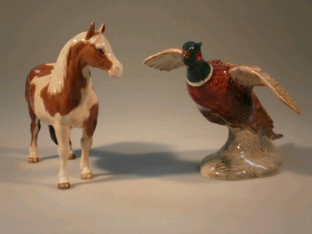 Appraisal: A Beswick model of a skewbold pony one hind leg