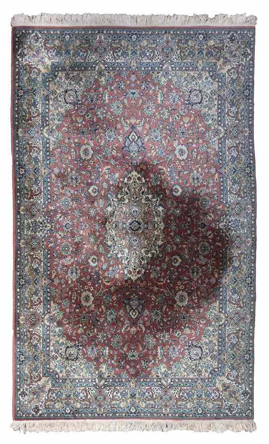 Appraisal: A Persian Wool Carpet having a floral and foliate medallion