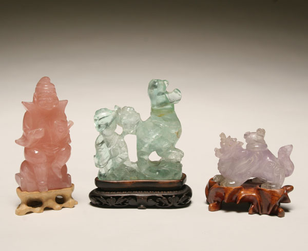 Appraisal: Three Chinese carvings on stands including a rose quartz fisherman