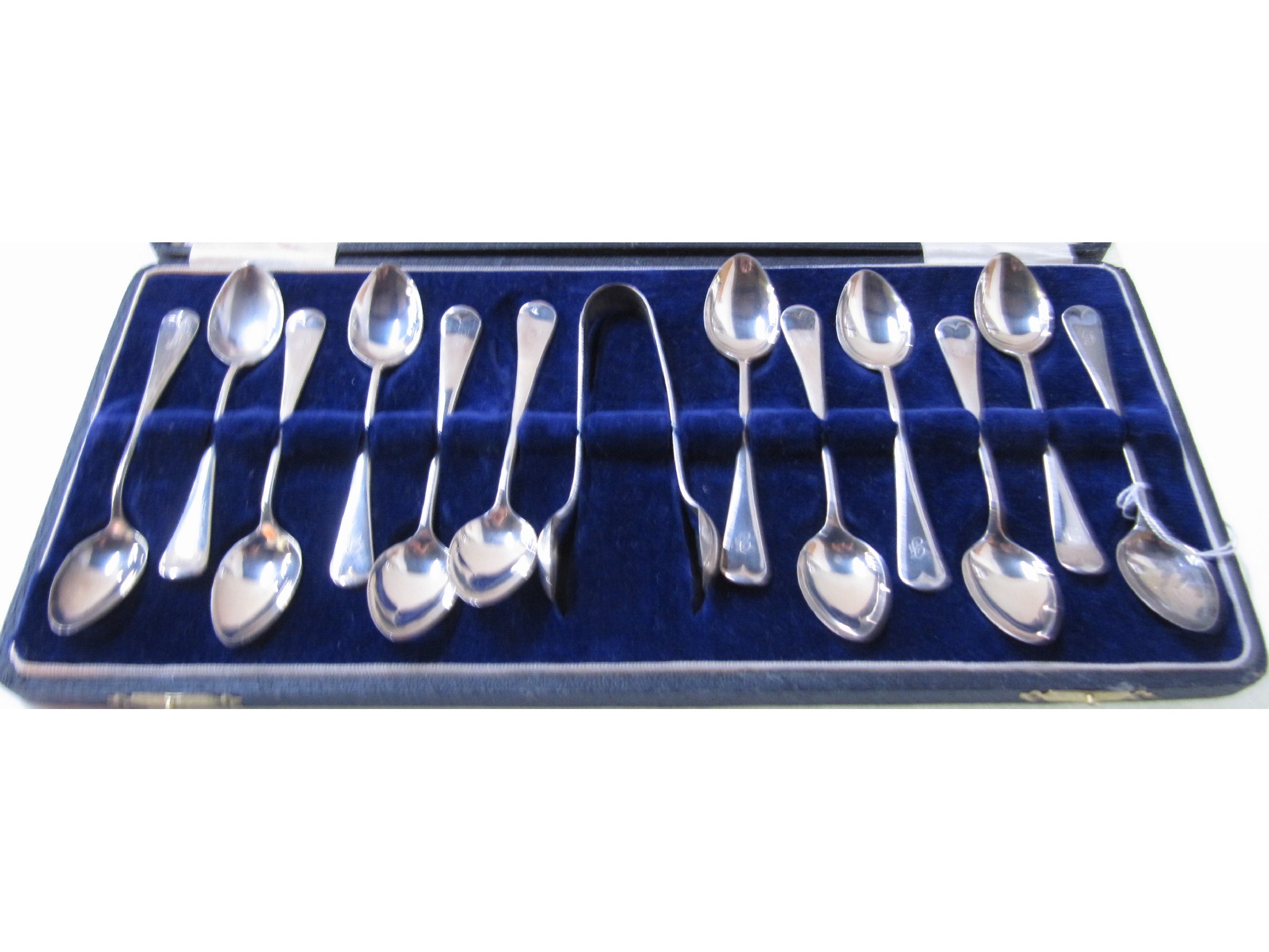 Appraisal: A cased set of twelve silver teaspoons with tongs Birmingham