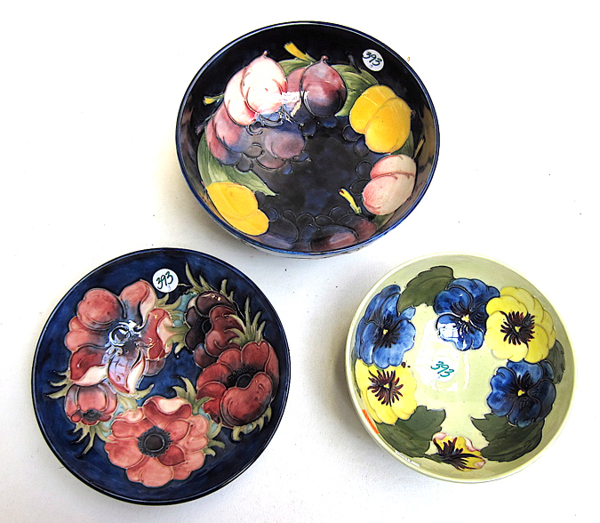 Appraisal: THREE MOORCROFT POTTERY BOWLS each hand painted under glaze and