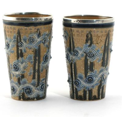 Appraisal: A pair of Doulton Lambeth stoneware beakers by George Tinworth