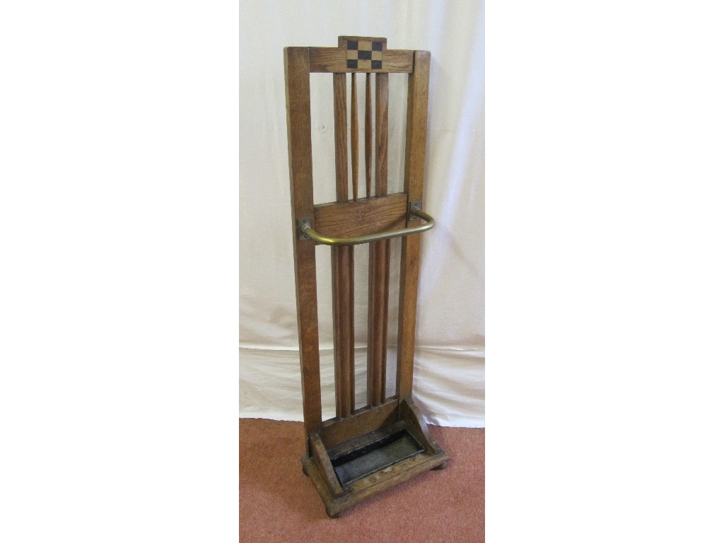 Appraisal: An Arts and Crafts oak stickstand decorated with bar back