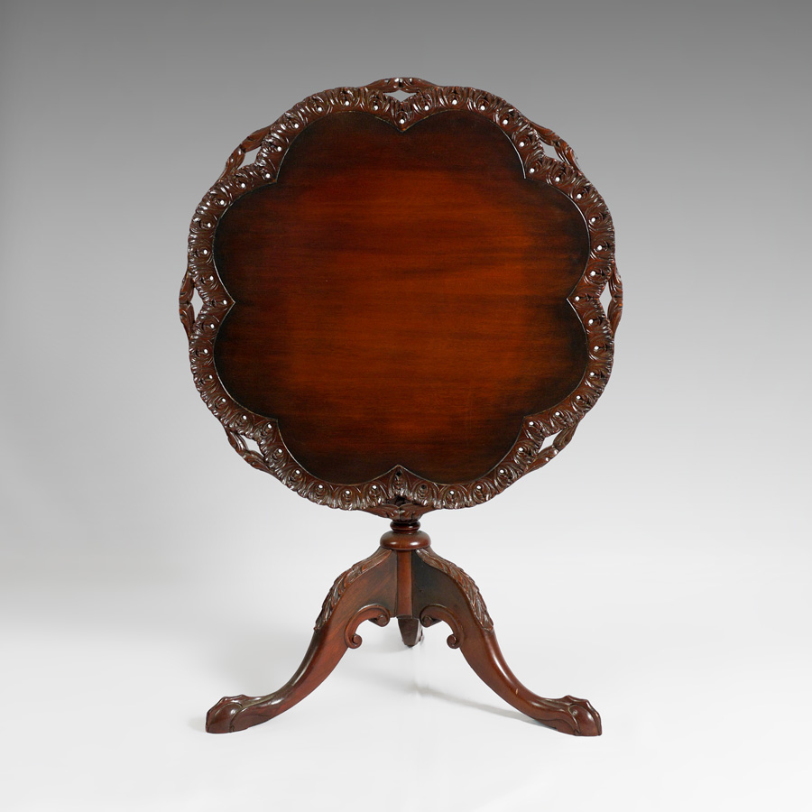 Appraisal: ORNATE CARVED MAHOGANY TILT TOP TABLE th century Chippendale style