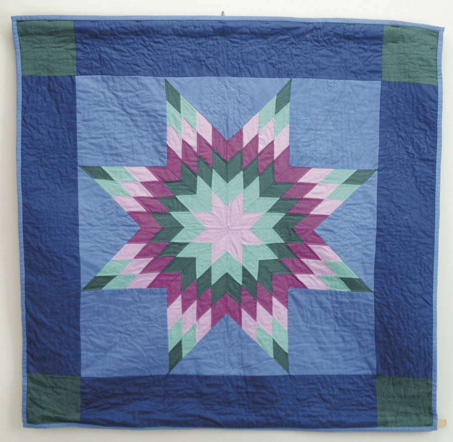 Appraisal: COLORFUL AMISH CRIB QUILT Central star design in light and