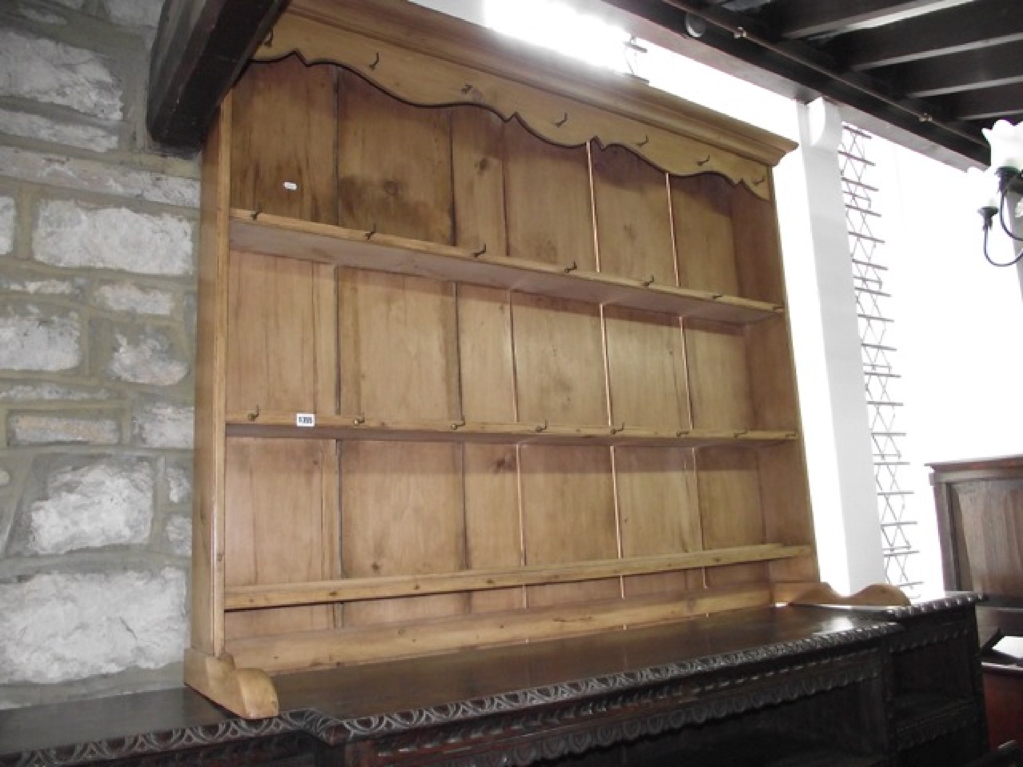 Appraisal: A stripped pine dresser plate rack with three open fixed