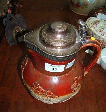 Appraisal: A stoneware harvest jug with white metal lid high