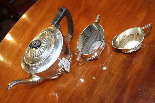 Appraisal: A THREE PIECE SILVER TEA SET oval teapot with fluted