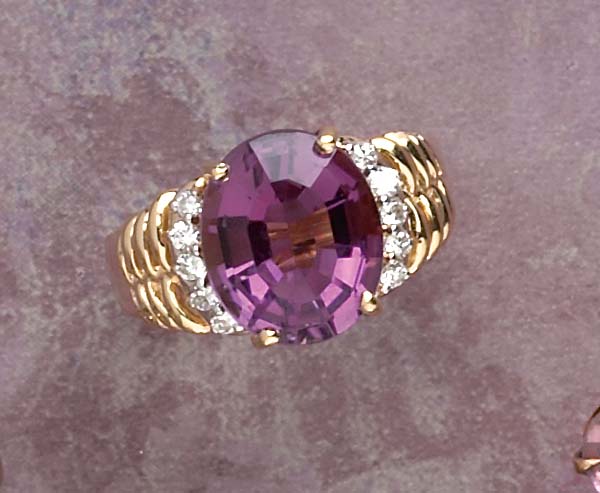 Appraisal: AMETHYST AND DIAMOND RING k yellow gold ring with spiral