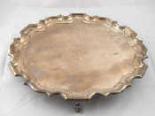 Appraisal: A silver waiter with chippendale rim on three leaf capped