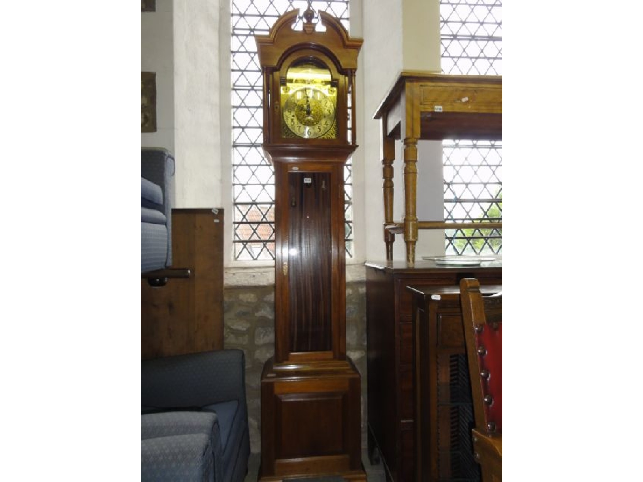 Appraisal: A reproduction longcase clock in the Georgian style the hood