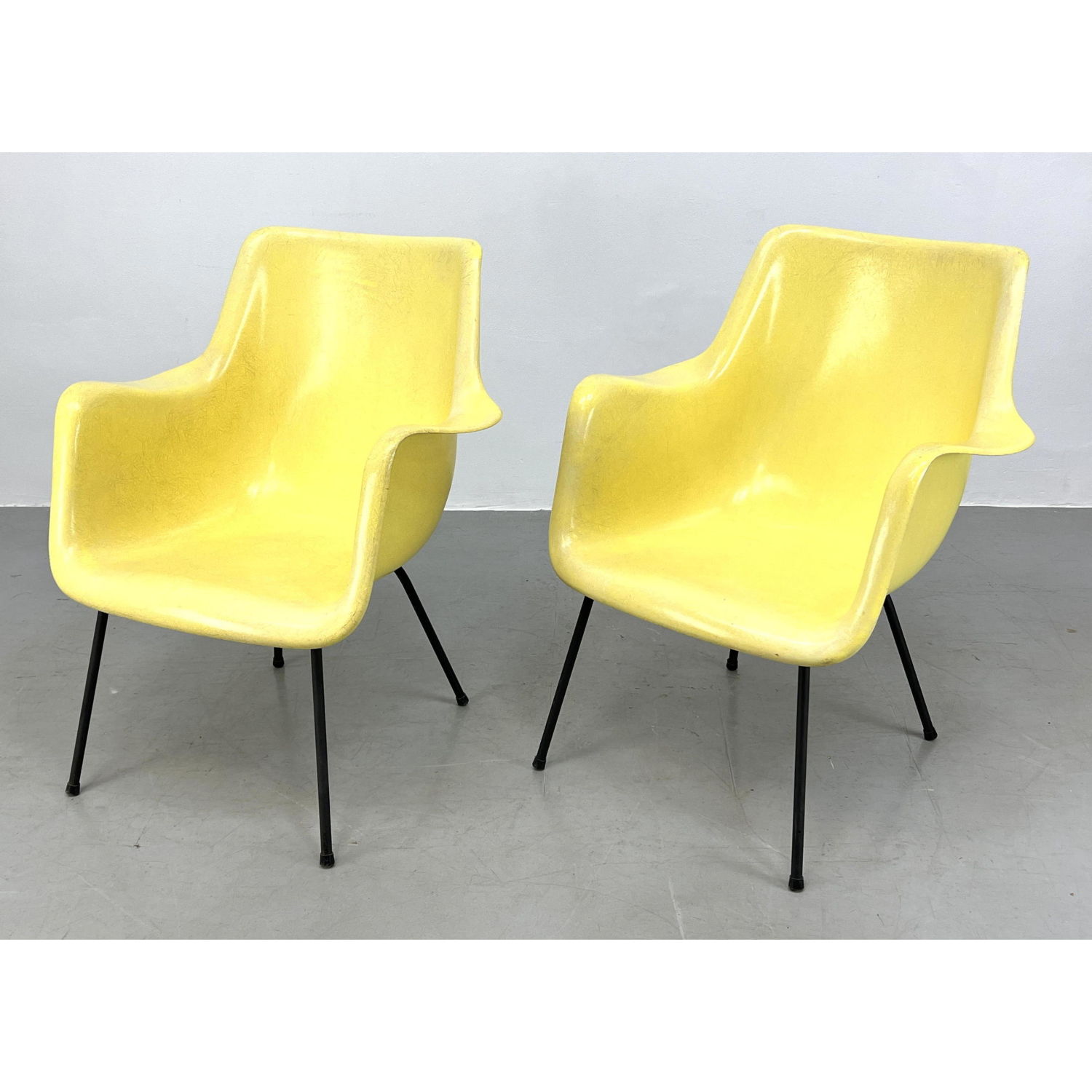 Appraisal: Pr Yellow Fiberglass Shell Lounge Chairs Flared Arms Black Metal