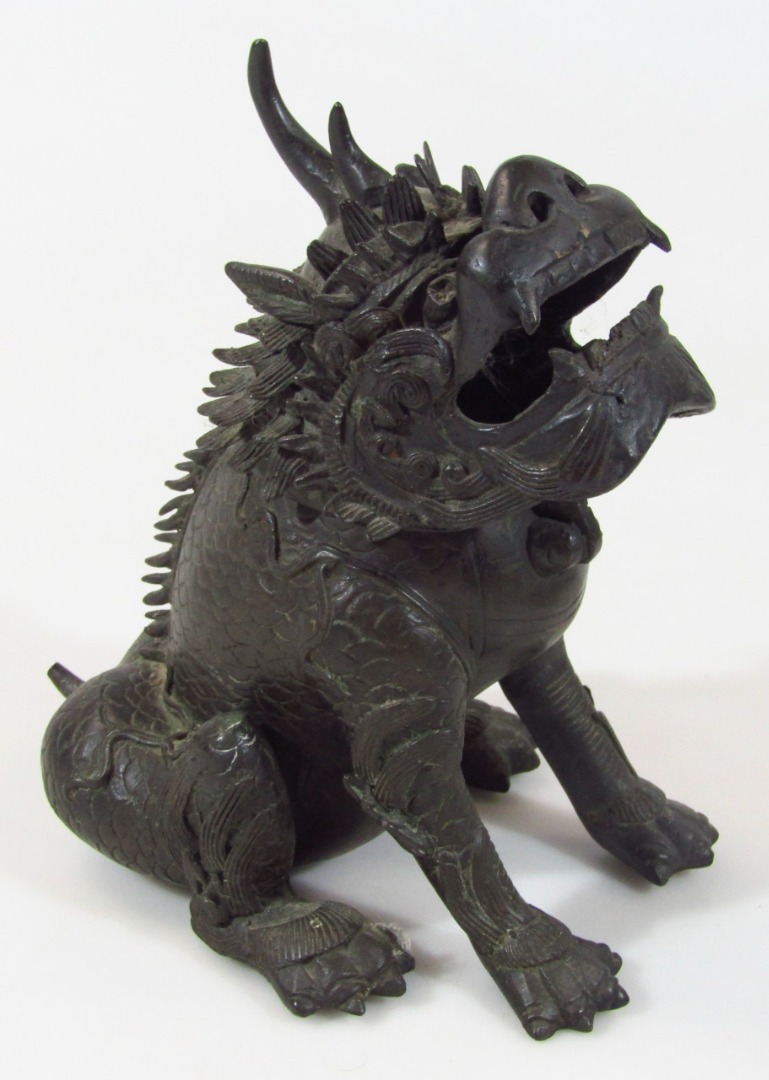 Appraisal: A Chinese bronze figure of a dragon in seated position