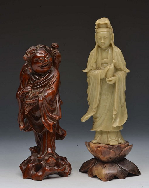 Appraisal: A CHINESE CARVED SOAPSTONE MODEL OF GUANYIN cm and a