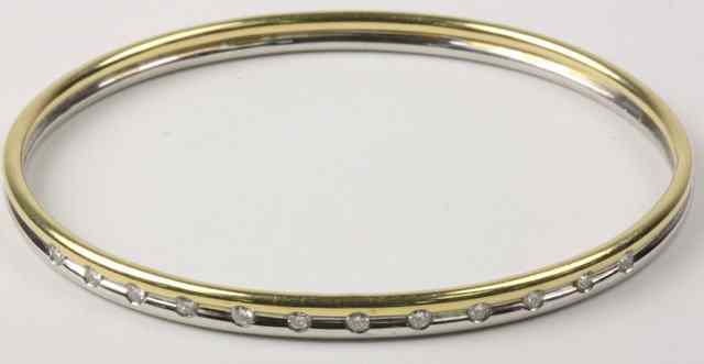 Appraisal: A diamond set ct white and yellow gold bangle recess