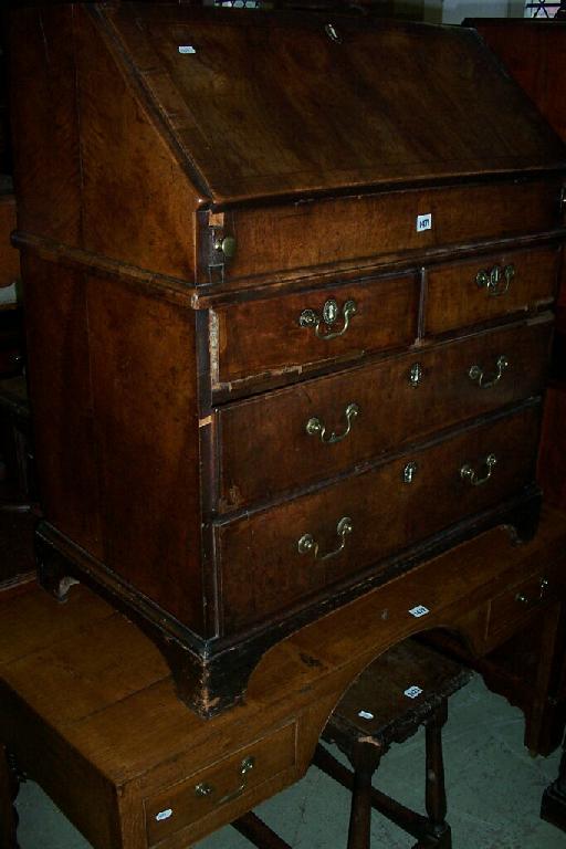 Appraisal: An th century walnut bureau of long and short drawers