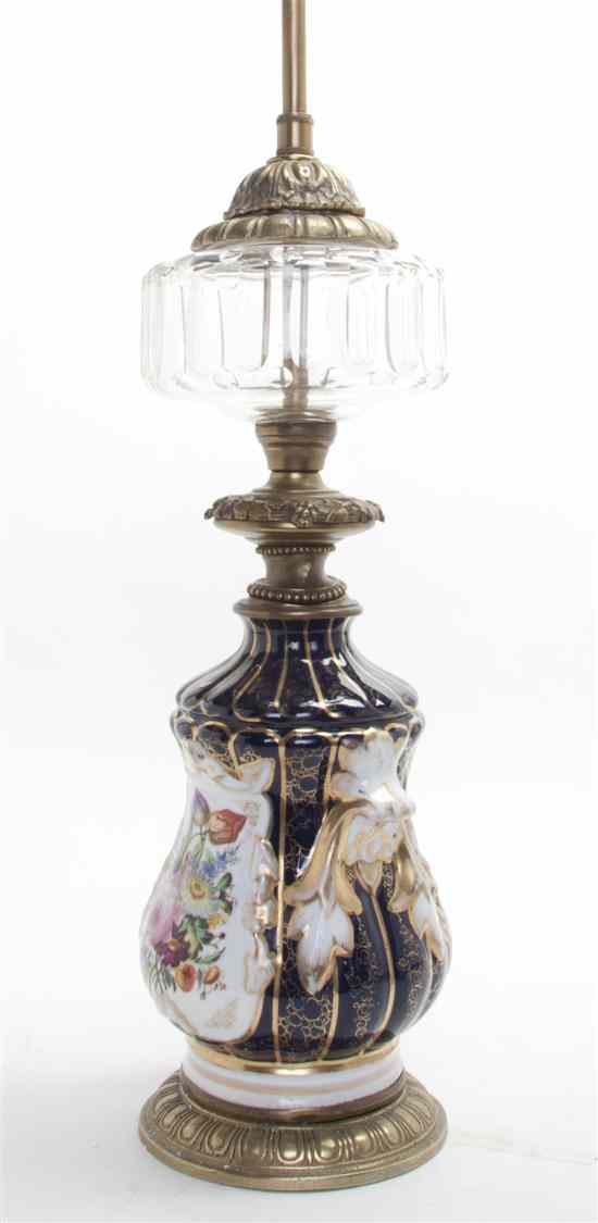 Appraisal: A Continental Porcelain Fluid Lamp Base having a glass reservoir