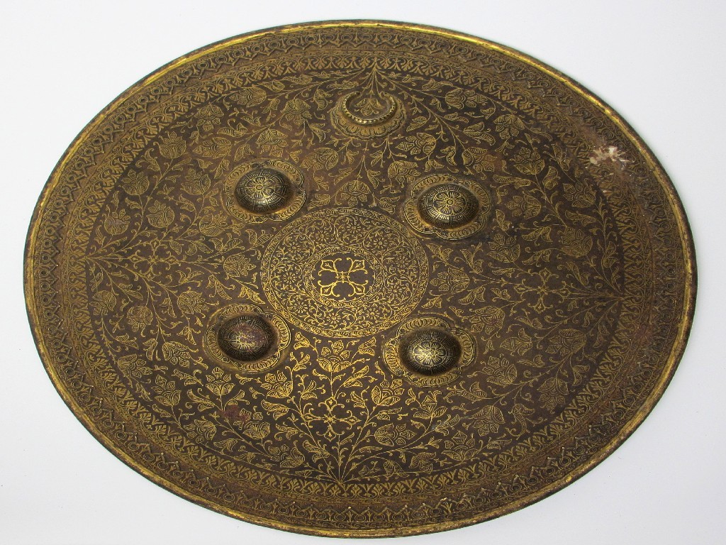 Appraisal: A Persian damascened shield decorated with flowers between raised bosses