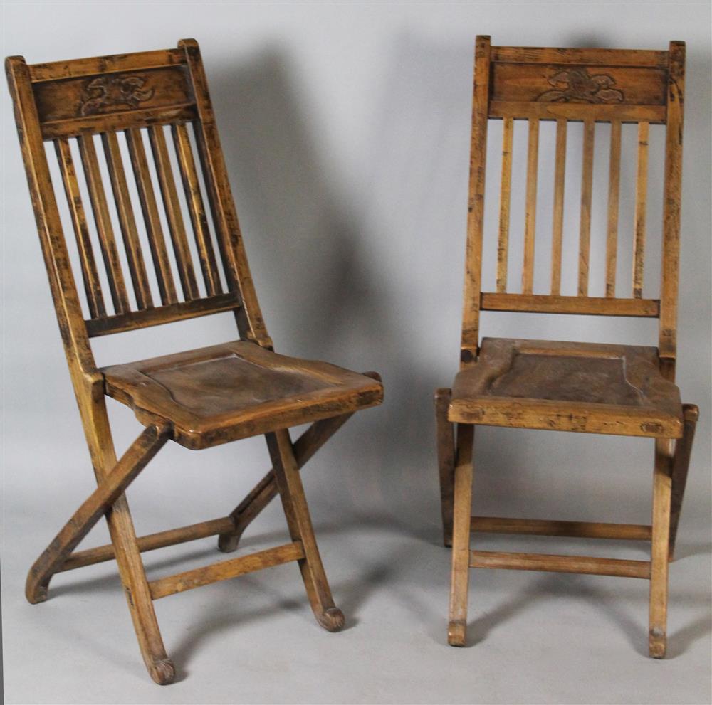 Appraisal: PAIR OF CHINESE STYLE CARVED ELMWOOD FOLDING CHAIRS each with