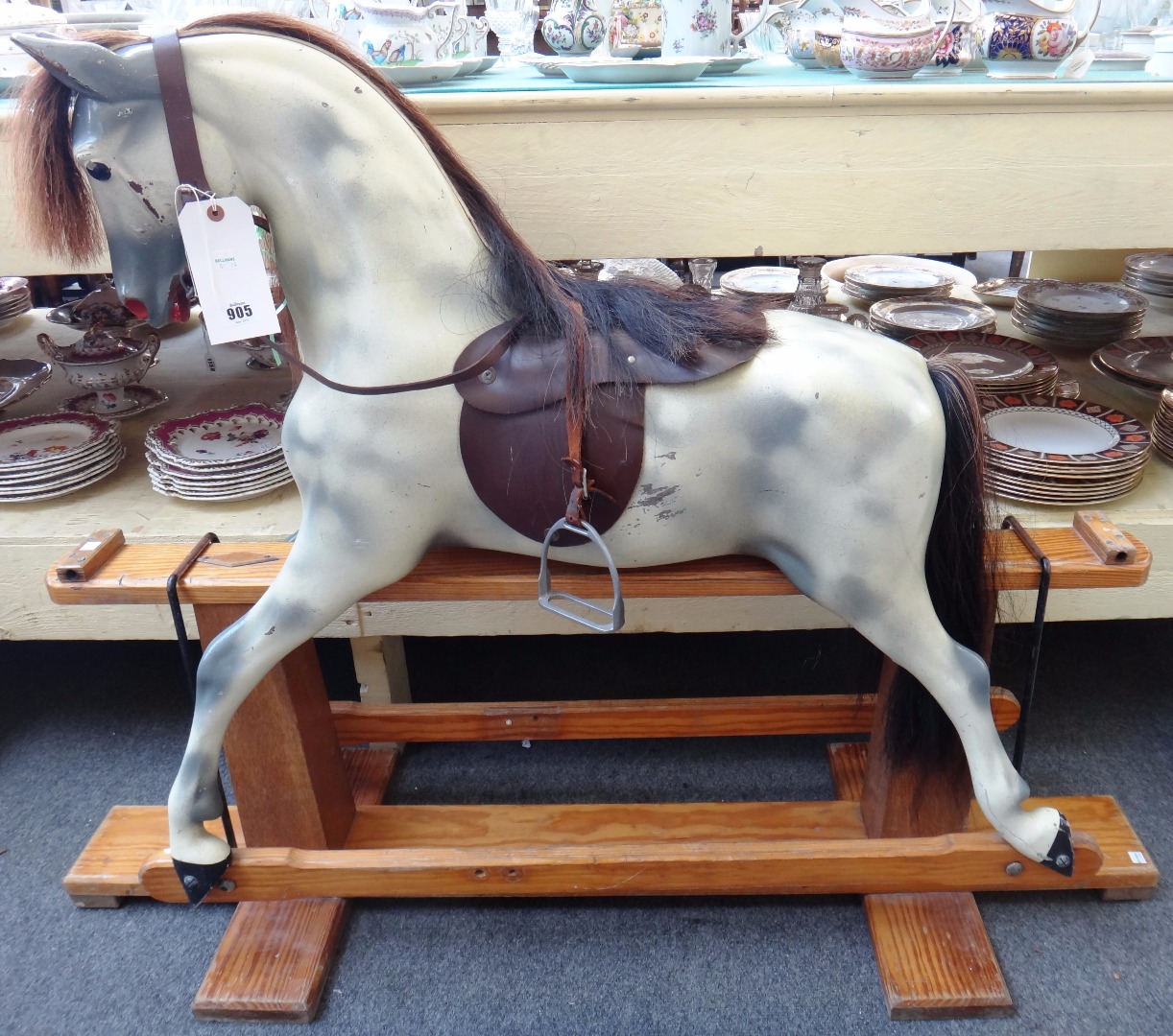 Appraisal: A dapple grey rocking horse on a pine swing frame