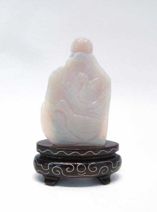 Appraisal: CHINESE CARVED OPAL SNUFF BOTTLE with conforming wood stand Height