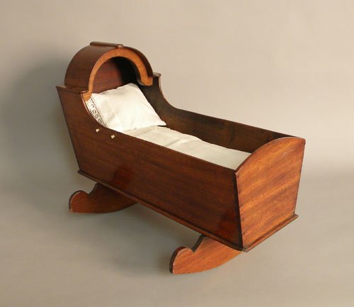 Appraisal: George IV Irish mahogany doll cradle with arched bonnet and