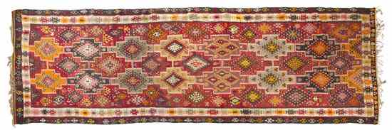 Appraisal: A Kilim Flatweave Wool Rug having repeating geometric medallions within