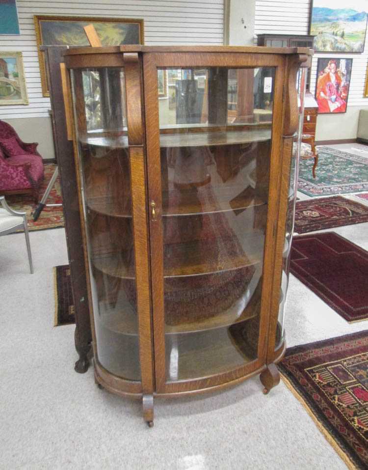 Appraisal: AN OAK AND CURVED GLASS CHINA CABINET Rockford Chair Furniture