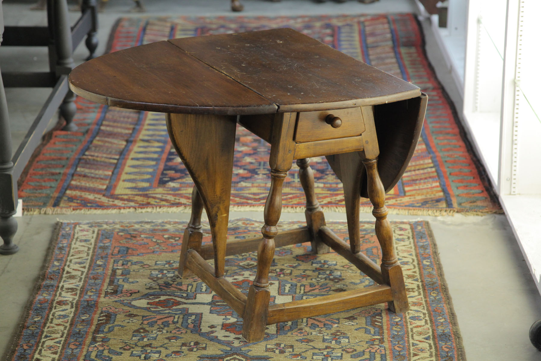 Appraisal: BUTTERFLY TABLE American th century Pine table with brown stain