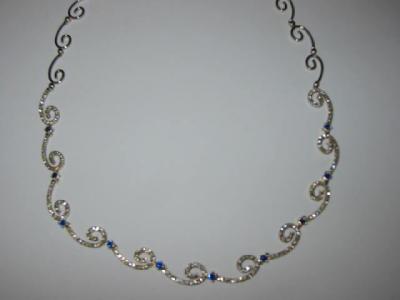 Appraisal: A SAPPHIRE AND DIAMOND NECKLACE having eleven diamond set scrolls