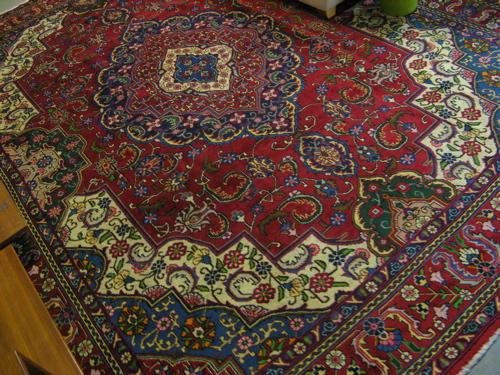 Appraisal: PERSIAN TABRIZ CARPET floral and central floral medallion design on