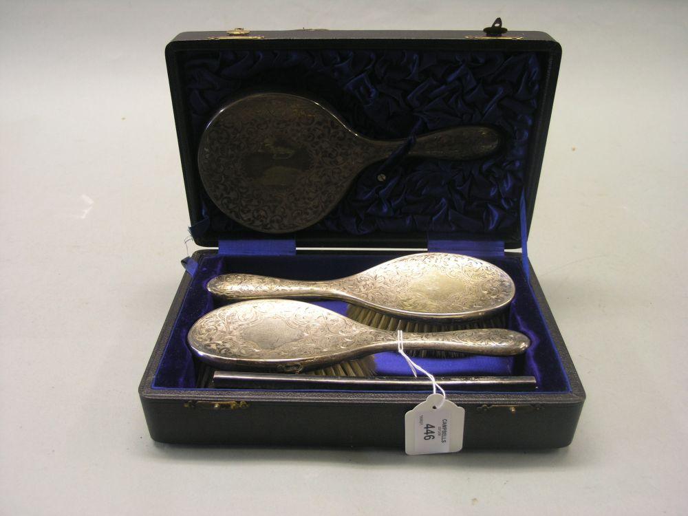 Appraisal: A cased silver dressing set consisting of hand mirror pair