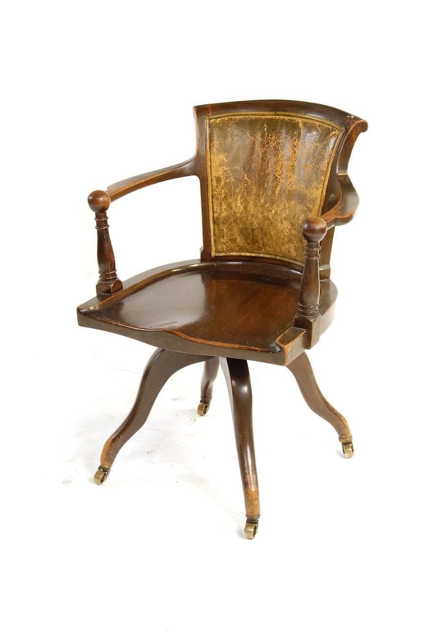 Appraisal: A mahogany revolving desk chair