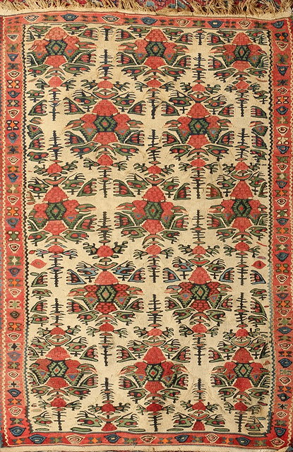 Appraisal: A PERSIAN TRIBAL KELIM RUG with stylised medallions on an