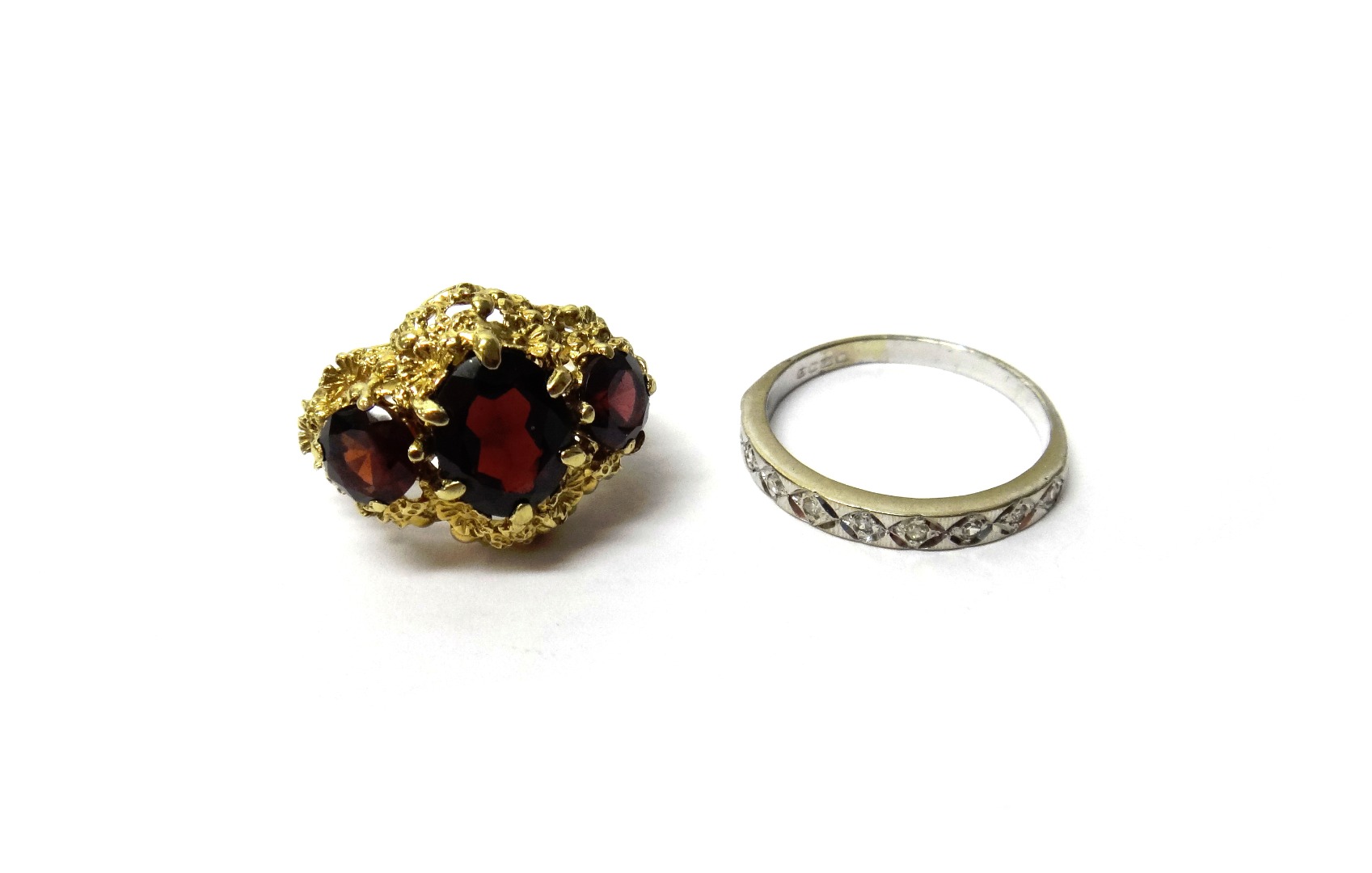 Appraisal: A ct gold and garnet set three stone ring cast