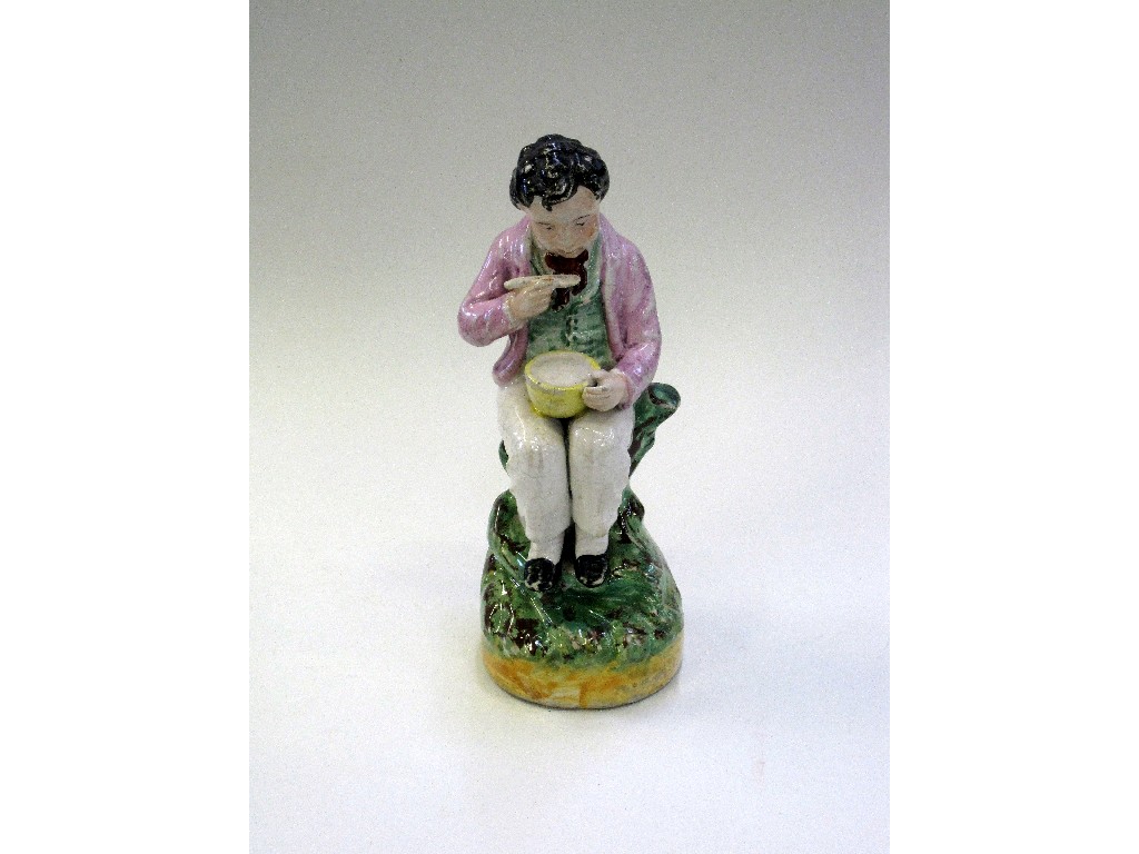 Appraisal: Staffordshire figure of a seated young boy eating from a