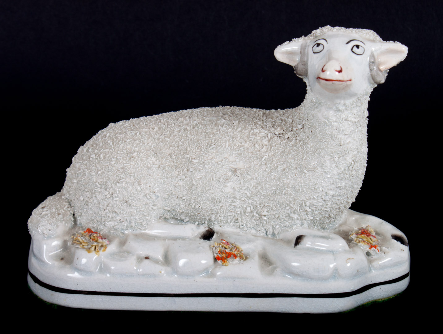 Appraisal: Staffordshire recumbent lamb mid- th century in H Condition Additional