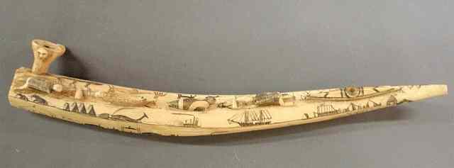 Appraisal: Eskimo carved walrus tusk pipe th c with scenes of