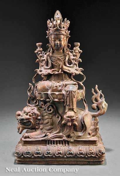 Appraisal: A Chinese Bronze Figure of Manjushri Atop a Lion probably