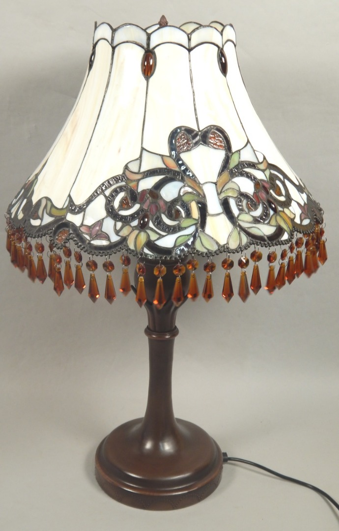 Appraisal: A modern Tiffany type stained glass and bronzed table lamp